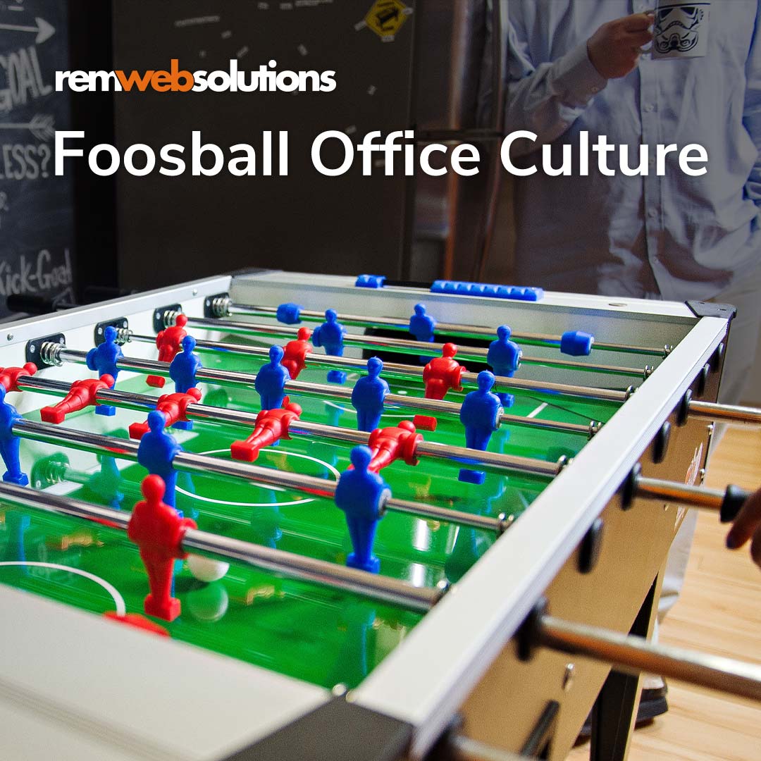 Todd playing foosball in the office