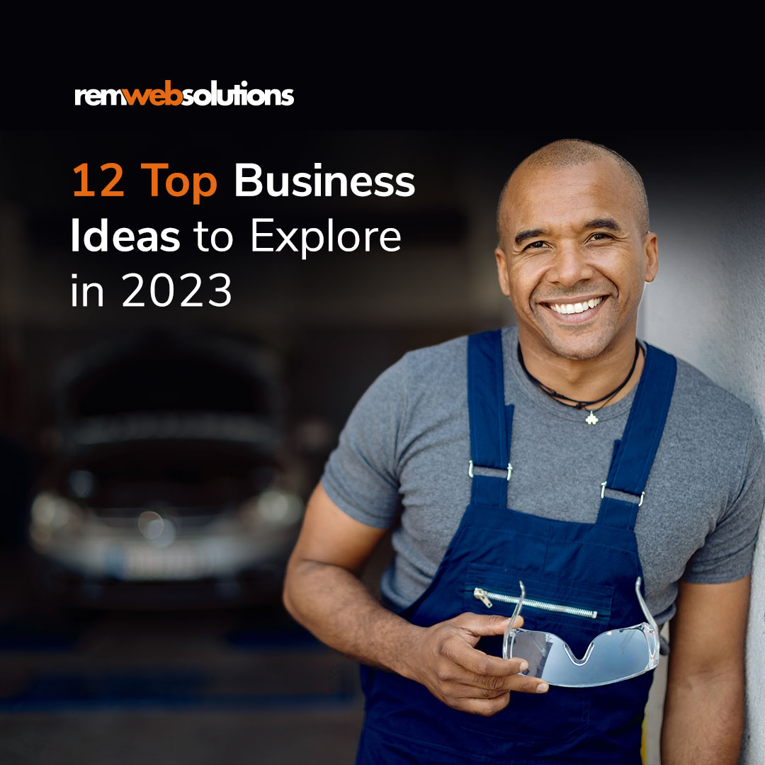 Man working at an auto shop wearing overalls and smiling