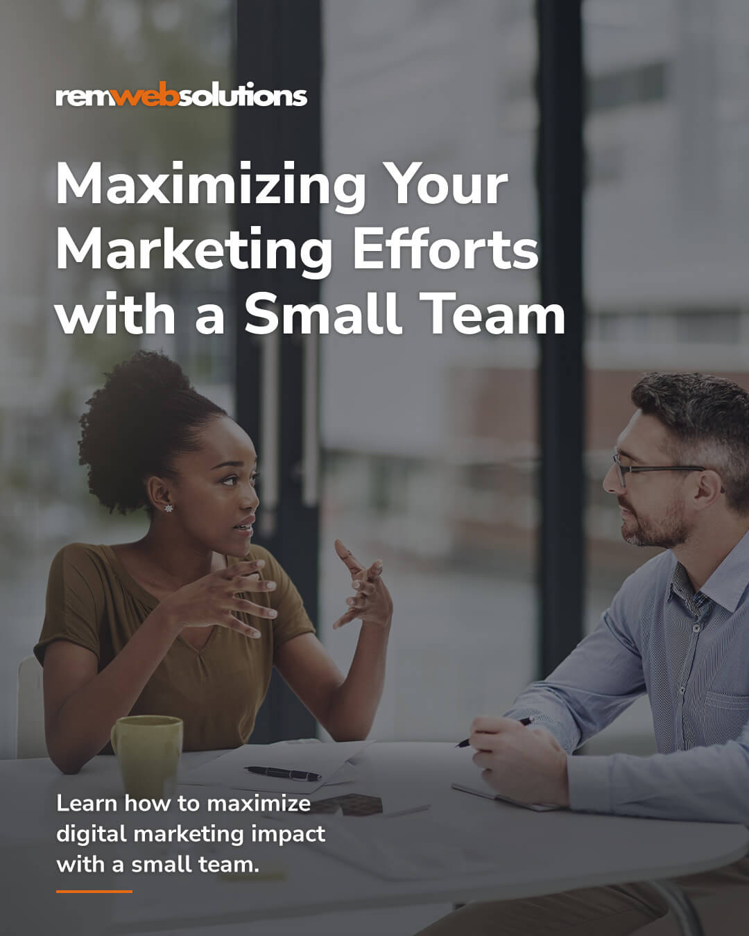 Small marketing team conversing at board room table