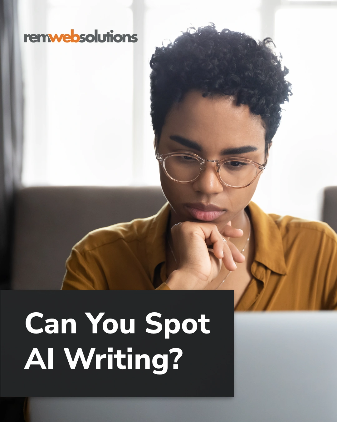 Woman looking at her laptop in living room.