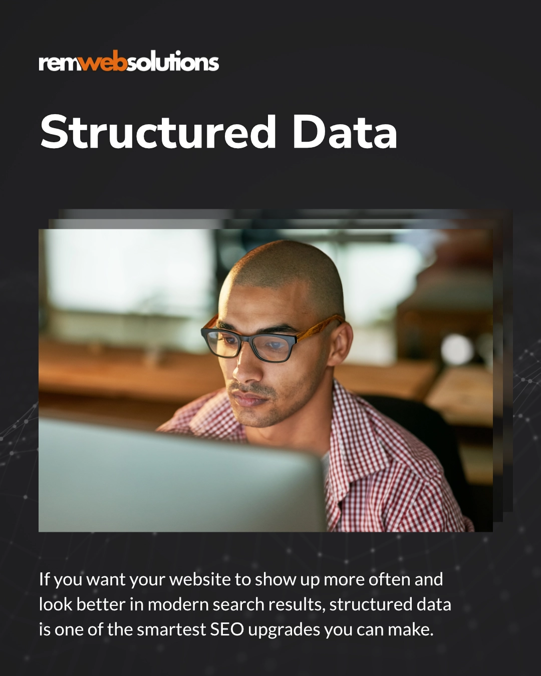 Man looking at desktop computer in dim room