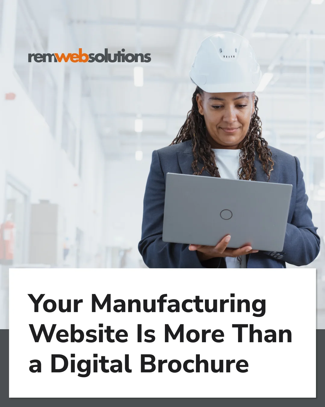Portrait of a black female engineer in hard hat standing and using laptop computer at electronic manufacturing factory